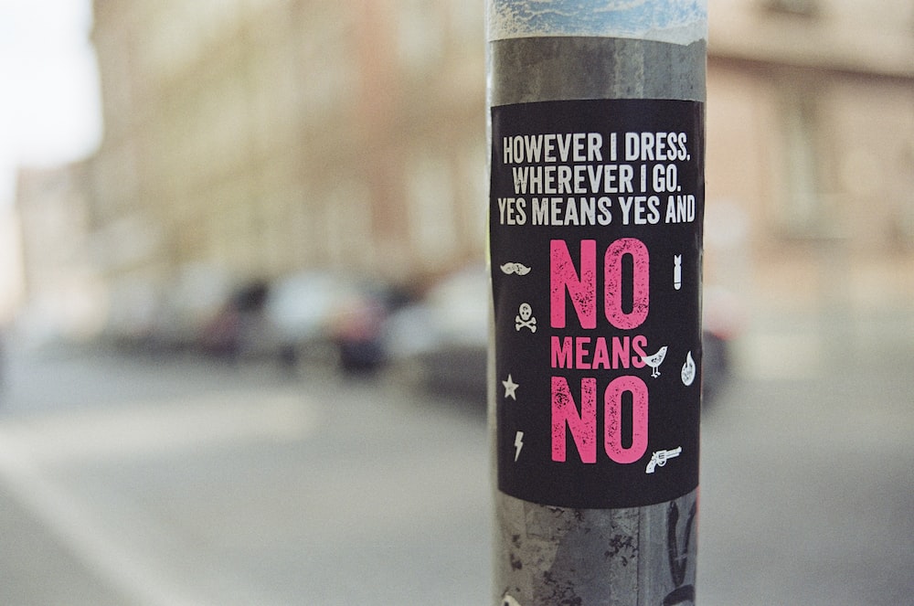 A pole sticker reading ‘However I Dress, Wherever I Go, Yes Means Yes, And No Means No’