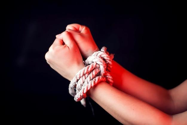 A child’s hands bound with a white rope, symbolising international child abduction.